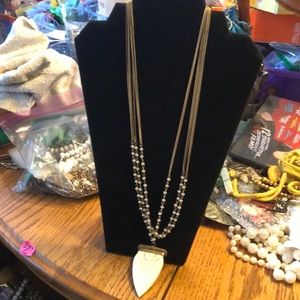 Necklace three tier. Gold tone. Faux ivory pendent.